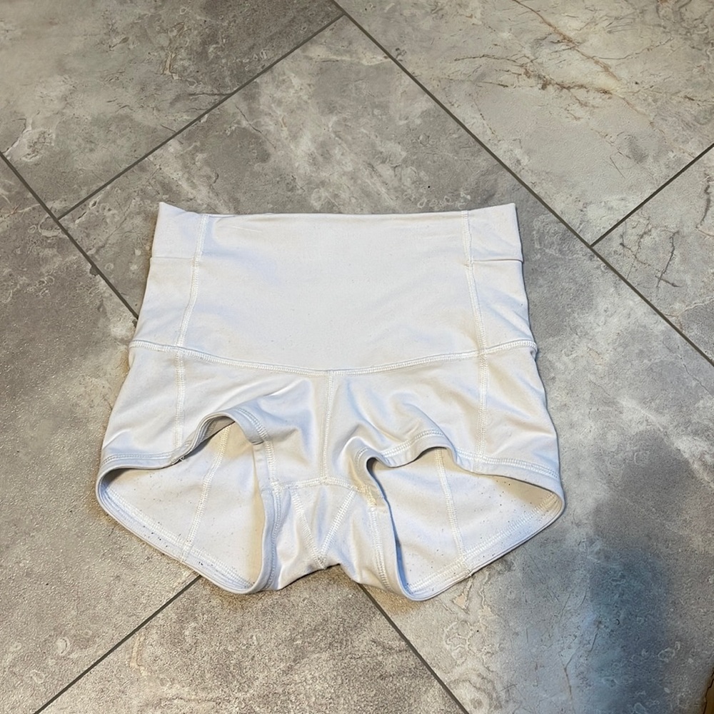 White lululemon shorts. High waisted that can fold over. Open pocket in back.